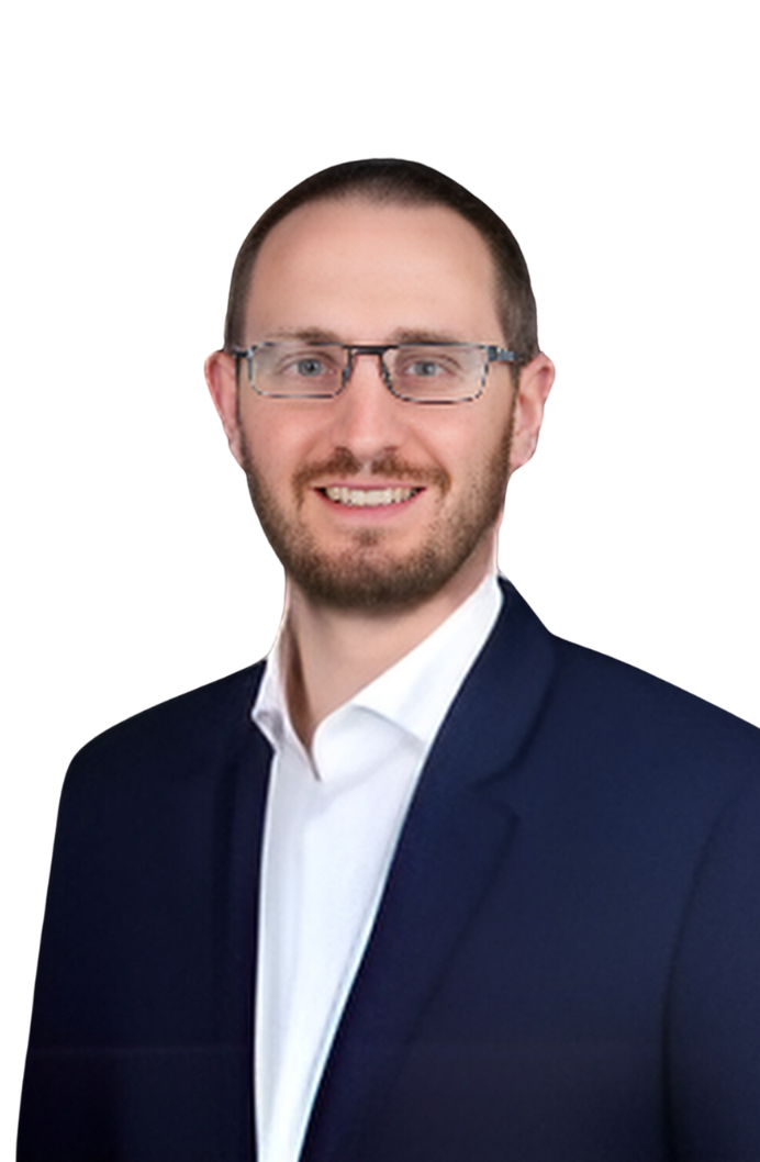 Portrait of Jack Grimshaw, CFO of Astoriom, wearing glasses and a dark blazer over a white shirt. He has a beard and is smiling, presenting a professional and friendly appearance.